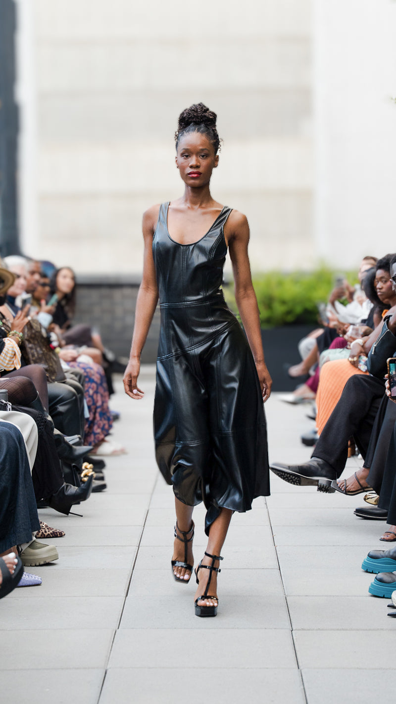 Eghahi Adikwu wearing a black vegan leather dress on Megan Renee's SS26 fashion show runway.