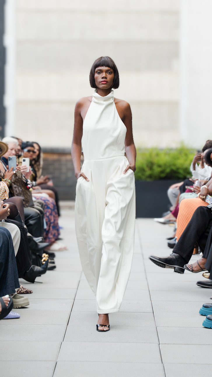 London Knight wearing a white vegan leather jumpsuit on Megan Renee's SS26 fashion show runway.