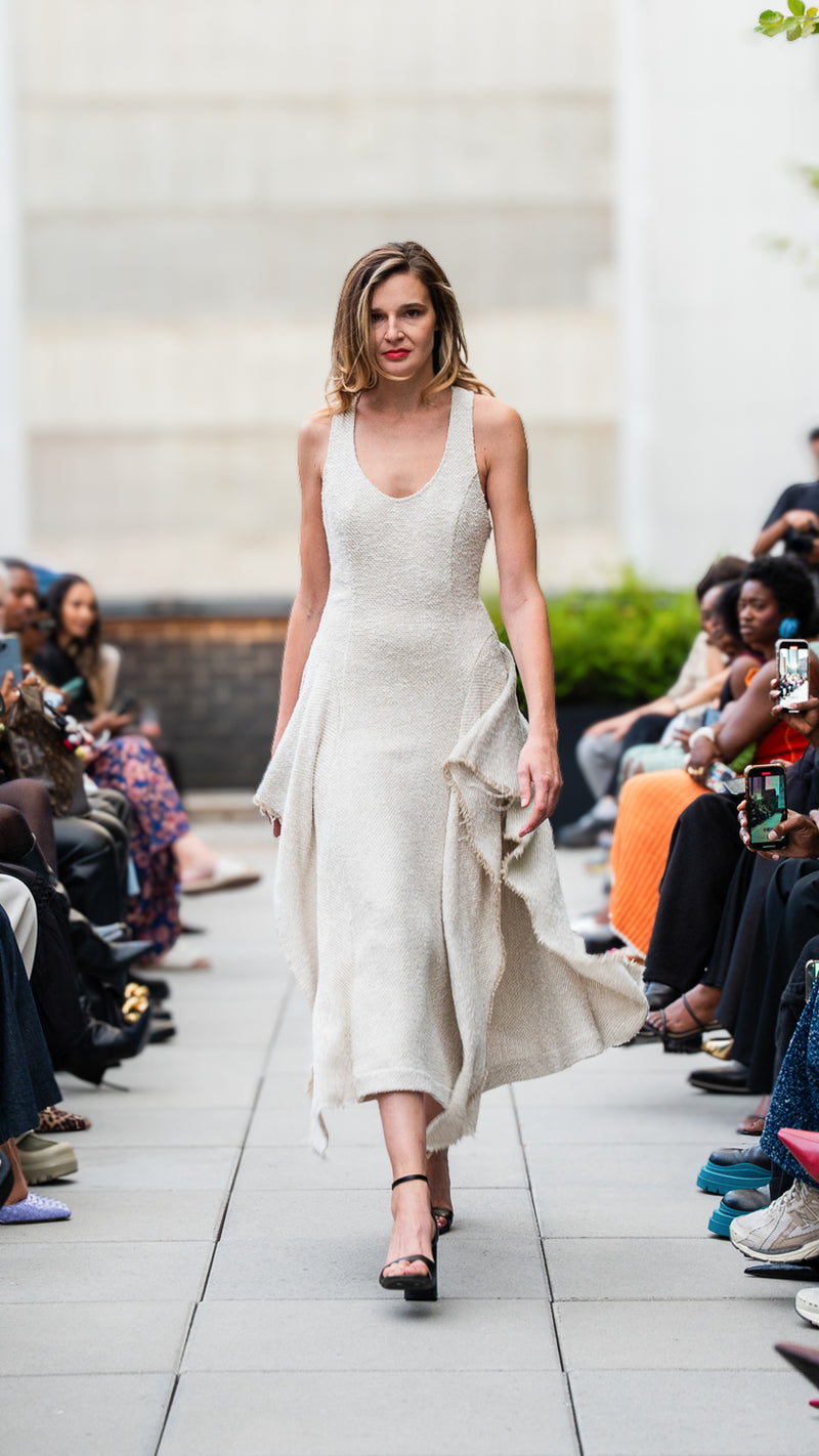 McKenna Joy wearing a beige boucle dress on Megan Renee's SS26 fashion show runway.